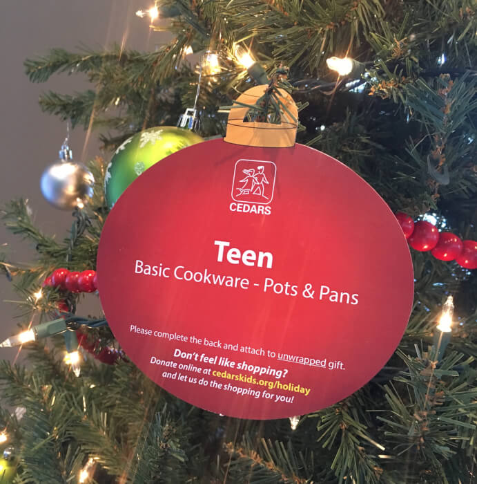 IMG: ornament on tree explaining needs of children for christmas
